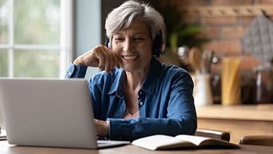 woman smiling with laptop open