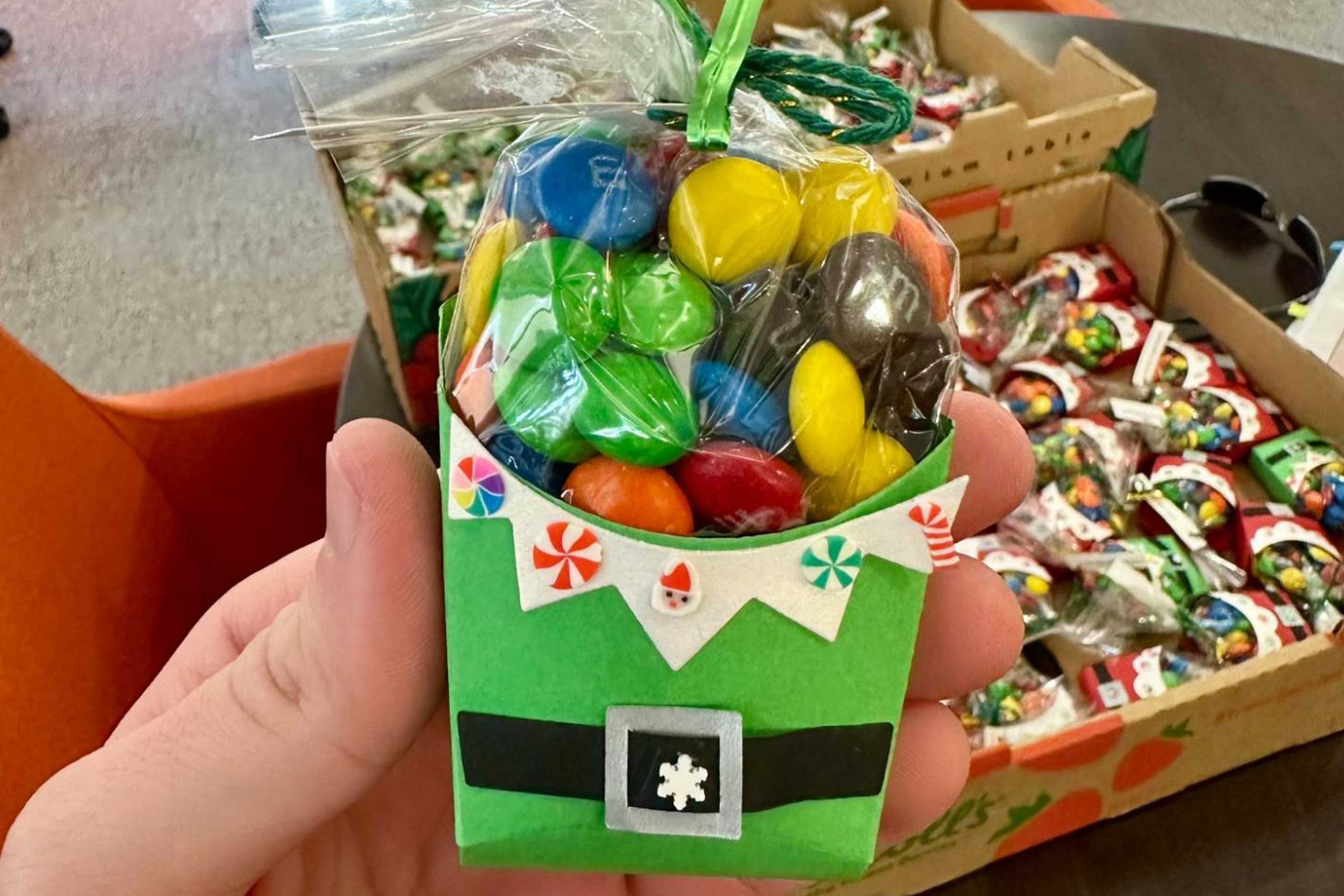 VIPs crafting holiday gifts, cards, and gift tags together during a festive community event.