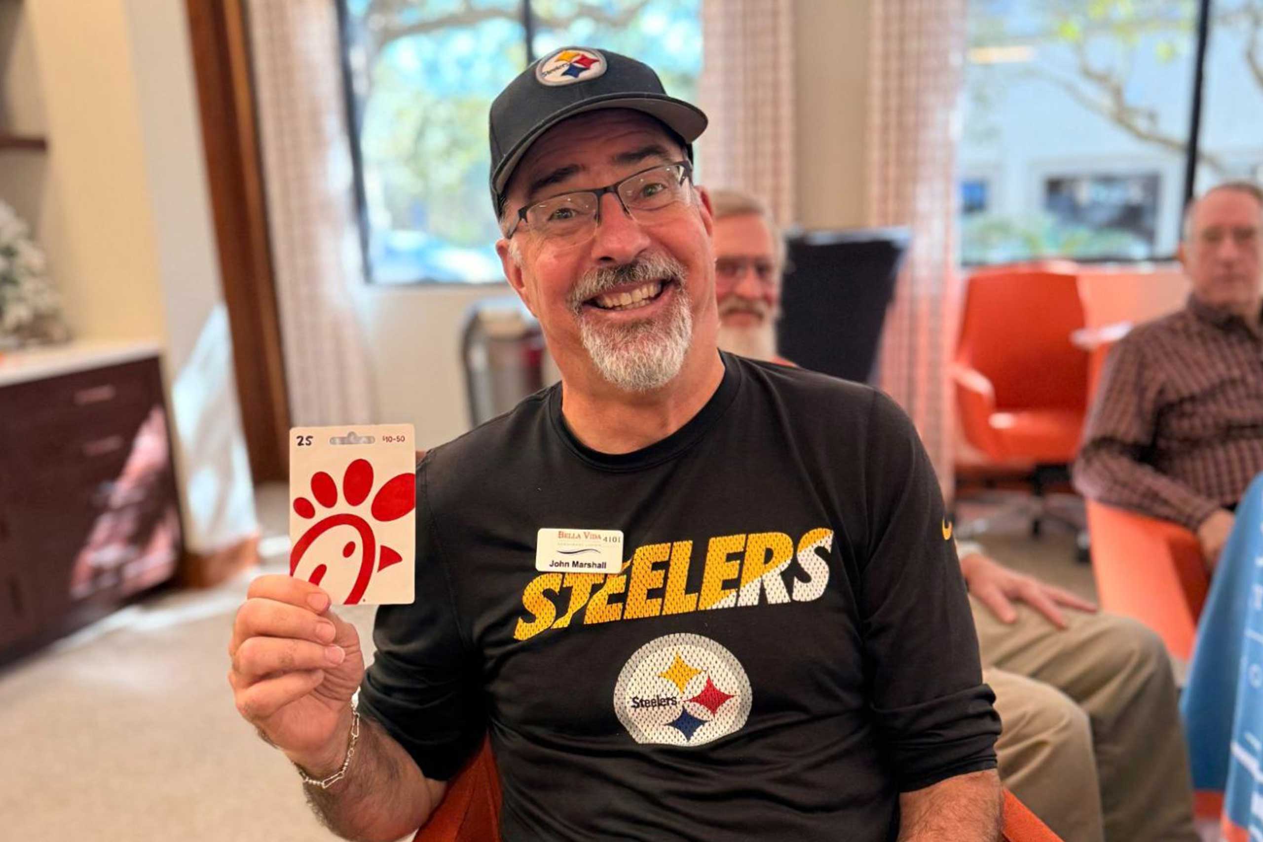 Male VIPs enjoying a game-day event, watching the Myrtle Beach Bowl between Kennesaw State and Western Michigan, playing Football Squares, and sharing food and prizes.