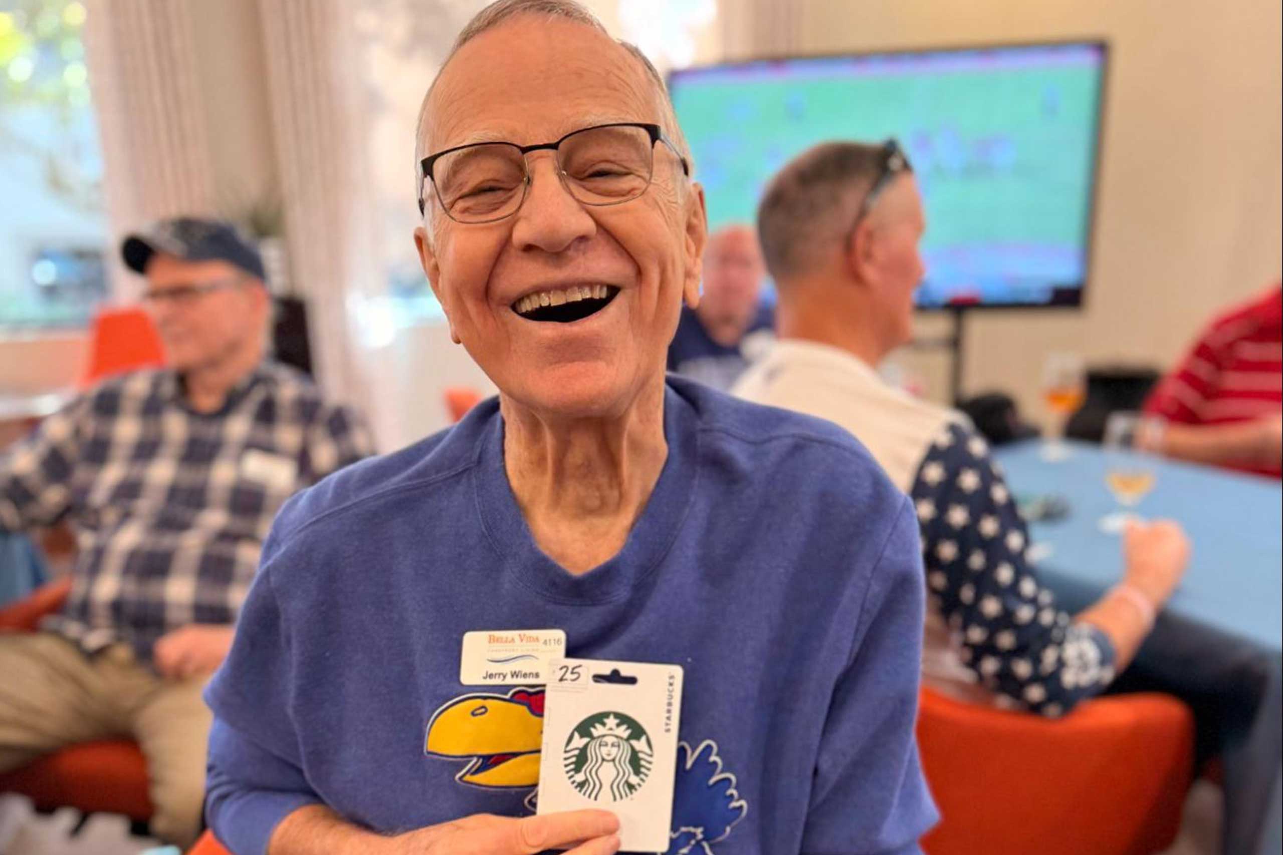 Male VIPs enjoying a game-day event, watching the Myrtle Beach Bowl between Kennesaw State and Western Michigan, playing Football Squares, and sharing food and prizes.
