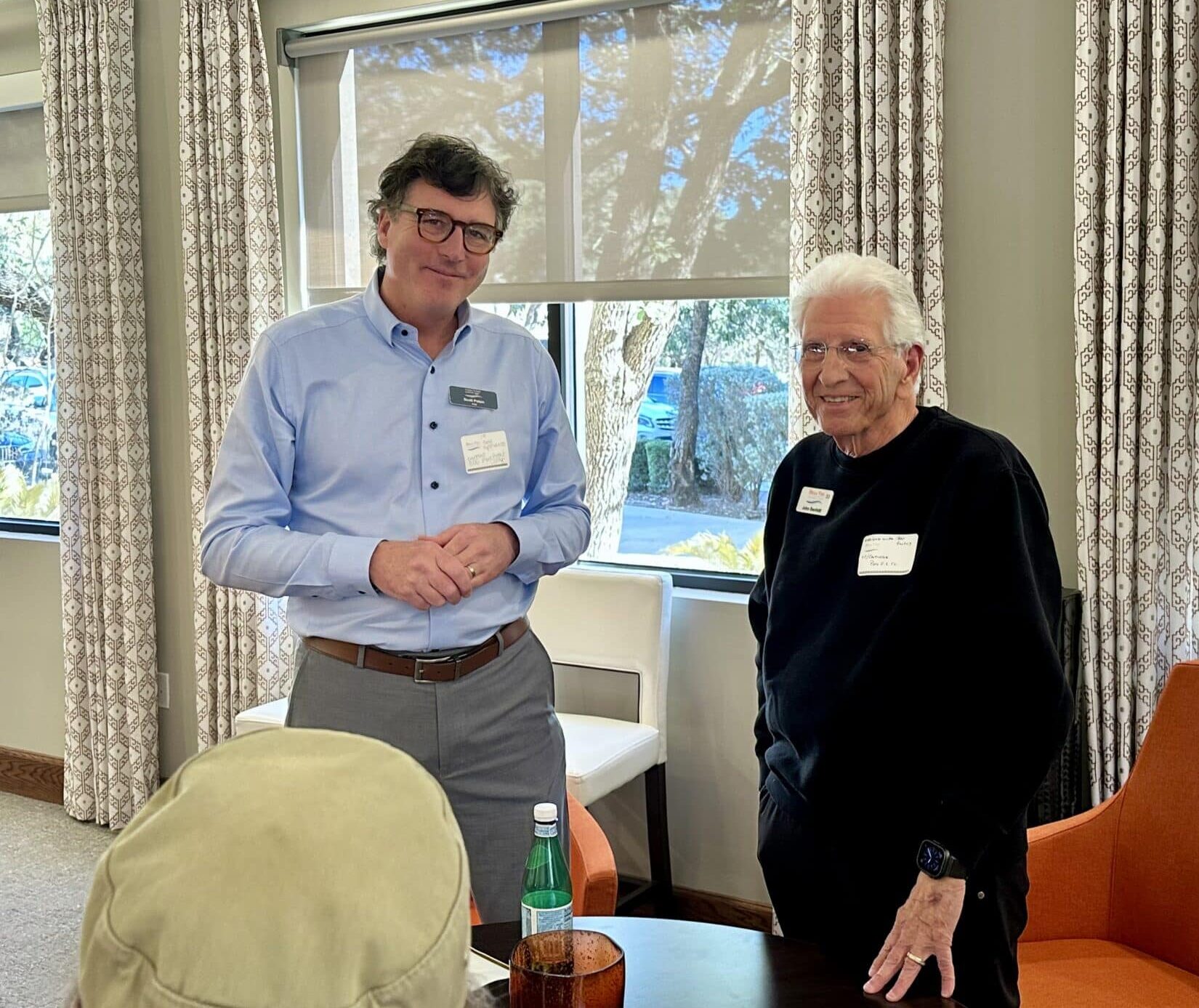 Bella Vida construction site with crews working on site walls, utilities, concrete slabs, and new framing at the Memory Care building, Phase 3 villas, and quadplex foundations.